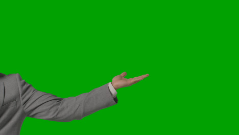 Close-Up-Of-Arm-Of-Businessman-In-Suit-Presenting-Or-Showing-Something-Against-Green-Screen-